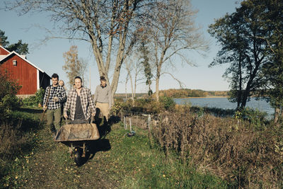 Multi-ethnic male and female farmers working at organic farm