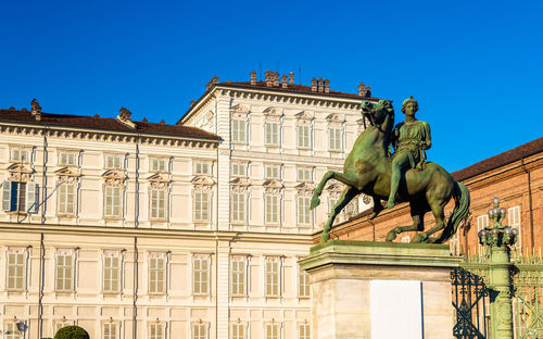 Low angle view of statue against clear blue sky