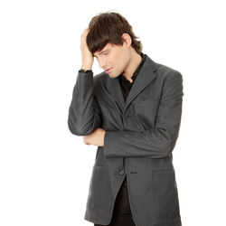 Young man standing against white background