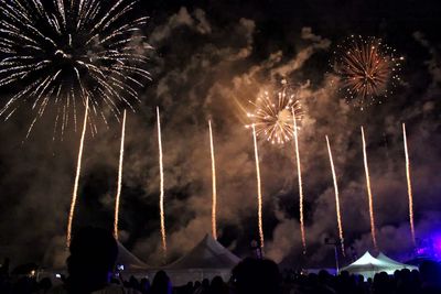 Low angle view of firework display at night