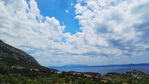 Scenic view of mountain range against cloudy sky