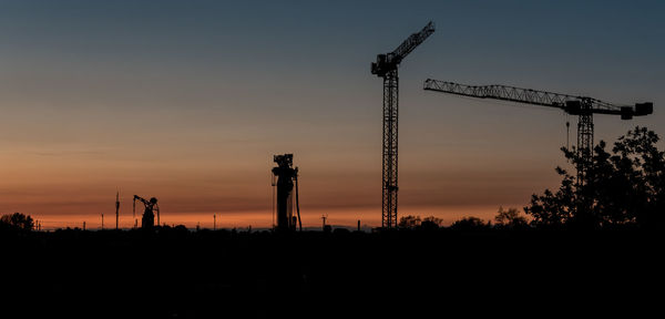 Low angle view of silhouette trees against sky at sunset