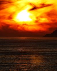 Scenic view of sea against romantic sky at sunset