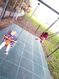 Rear view of children playing on floor