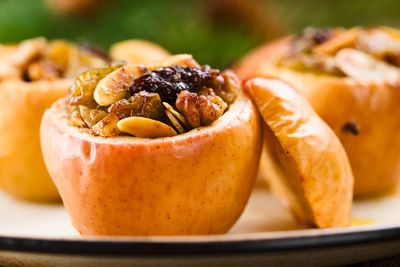 Close-up of apple with dry fruit on table