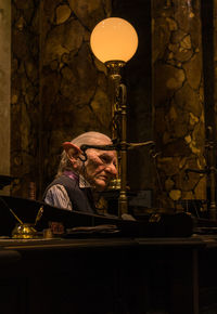 Man and woman sitting at illuminated table