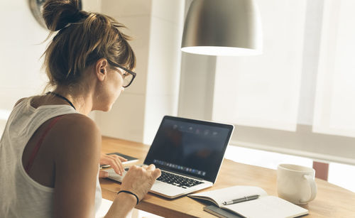 Woman using laptop at desk