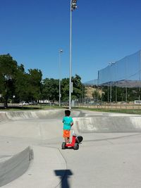 Rear view of boy against sky