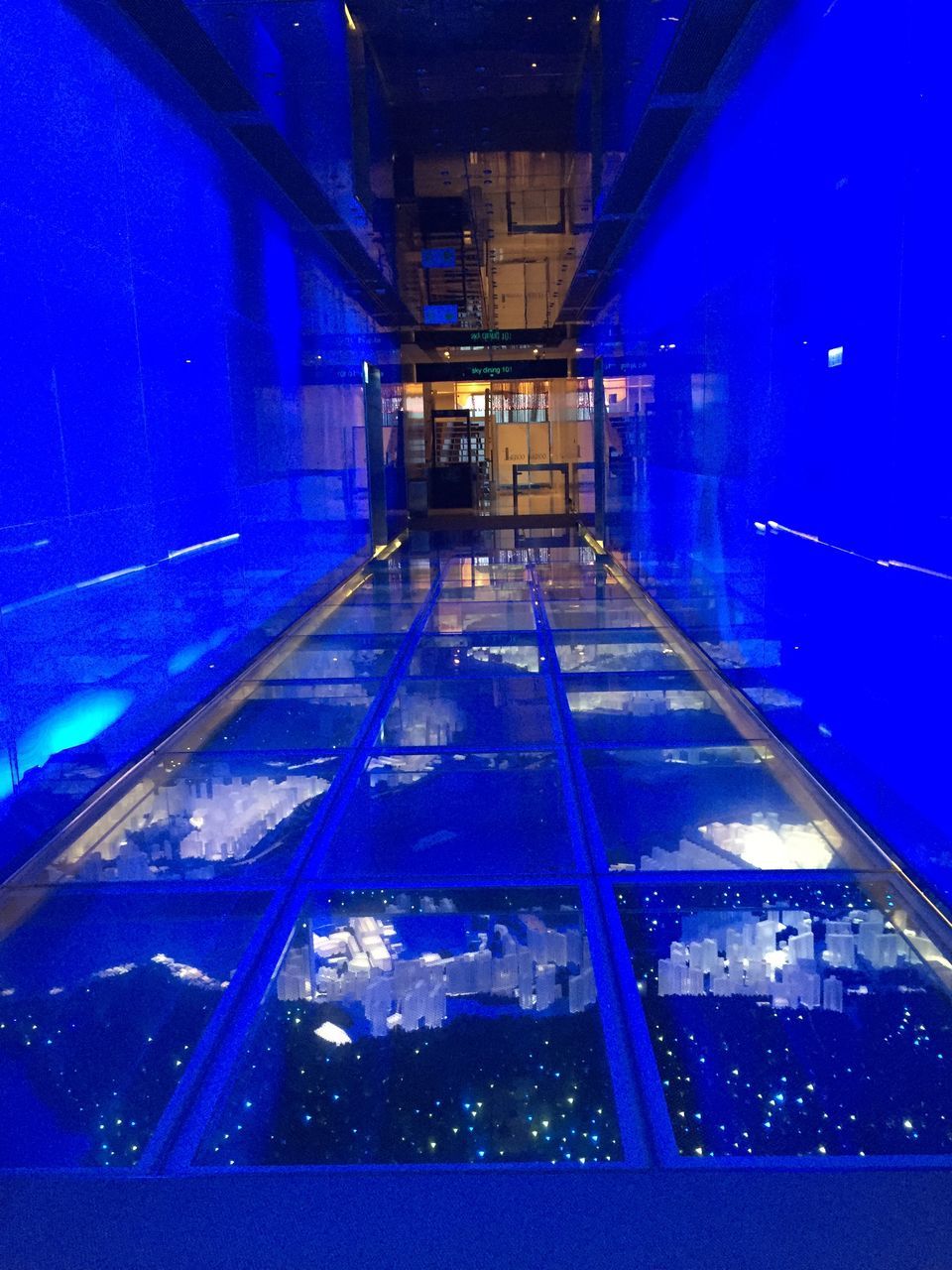 illuminated, architecture, blue, night, indoors, lighting equipment, no people, reflection, building, built structure, glass - material, window, diminishing perspective, transparent, direction, dusk, light, the way forward