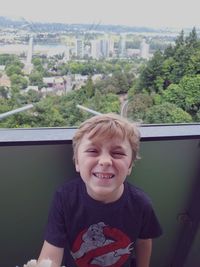 Portrait of smiling boy against window