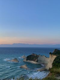 Scenic view of sea against clear sky at sunset