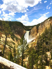 Scenic view of waterfall against sky