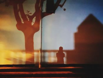 Close-up of figurine on table against sky during sunset