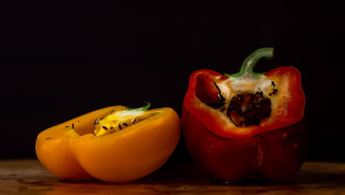 Close-up of fruits on table against black background