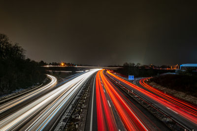 High angle view of light trails on highway at night