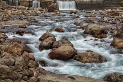 Scenic view of stream flowing through rocks