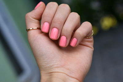 Close-up of hand with pink nail polish