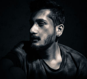 Portrait of man against black background