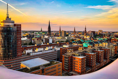 High angle view of buildings in city during sunset