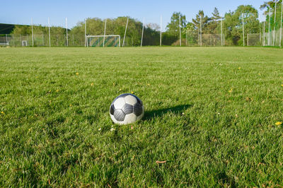 Soccer field with goal in the background and soccer ball in foreground. lots of copy space.