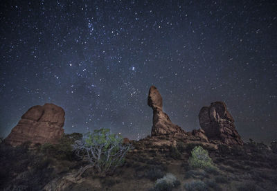 Rock formations against sky at night