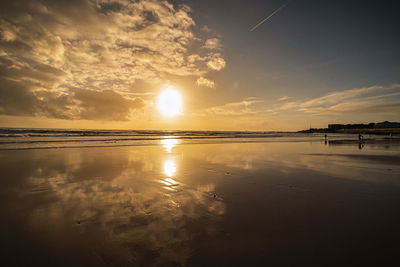 Scenic view of beach against sky during sunset