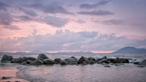 The rocks, waves, clouds and sky at kura-kura beach, singkawang - west of kalimantan.