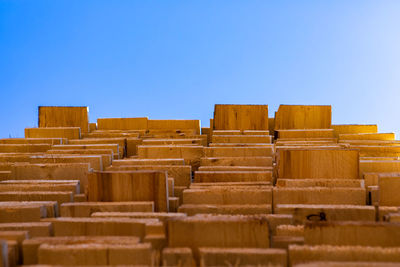 Stack of built structure against clear blue sky