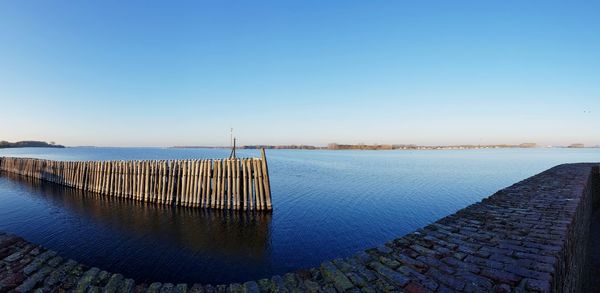 Scenic view of sea against clear blue sky