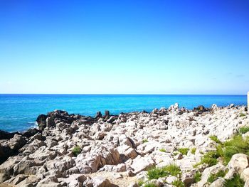 Scenic view of sea against clear blue sky