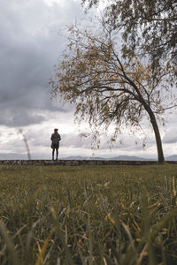 Man standing on field against sky