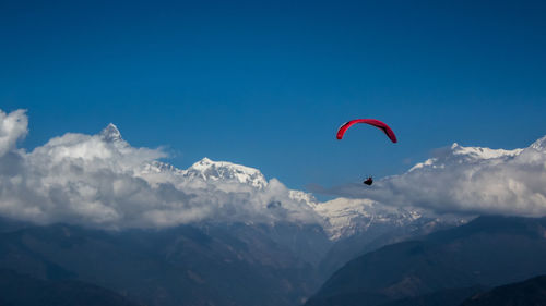 Paragliding over himalayas in clouds, pokhara nepal