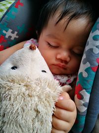 Close-up of cute baby girl sleeping with toy