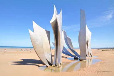 Panoramic view of beach against blue sky