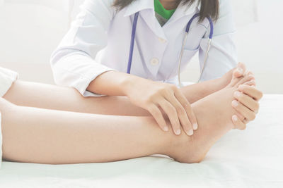 Midsection of woman sitting at home