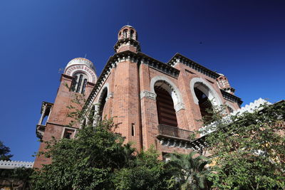 Low angle view of historical building against clear blue sky