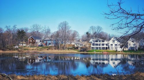 Reflection of trees and buildings in lake