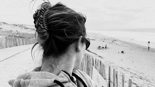 Close-up of woman at beach against sky