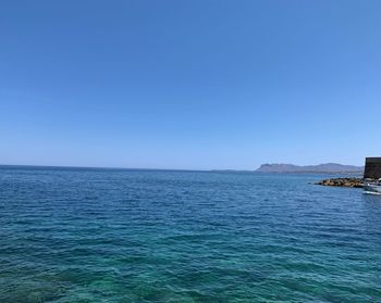 Scenic view of sea against clear blue sky