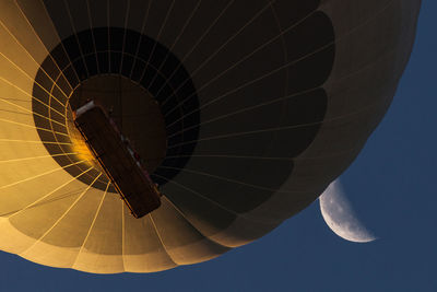 Low angle view of hot air balloon flying against sky