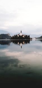 View of bird in lake against sky