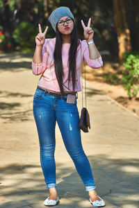 Portrait of young woman wearing sunglasses standing outdoors