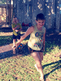 Full length of mother and girl on field
