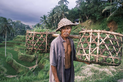 Portrait of woman standing on field