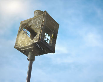 Low angle view of old street light against sky
