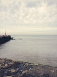 Scenic view of sea against cloudy sky