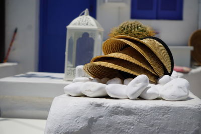 Close-up of white sculpture on table against building