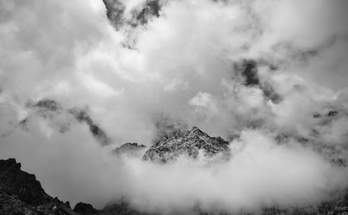 Clouds and fog cover the mountain peaks.