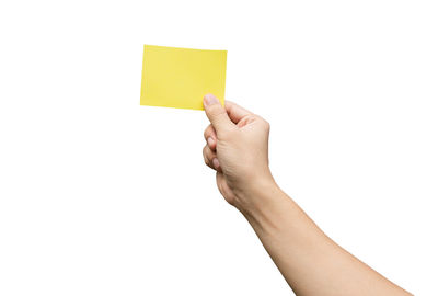 Midsection of person holding paper against white background