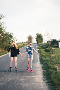 Friends roller skating on road